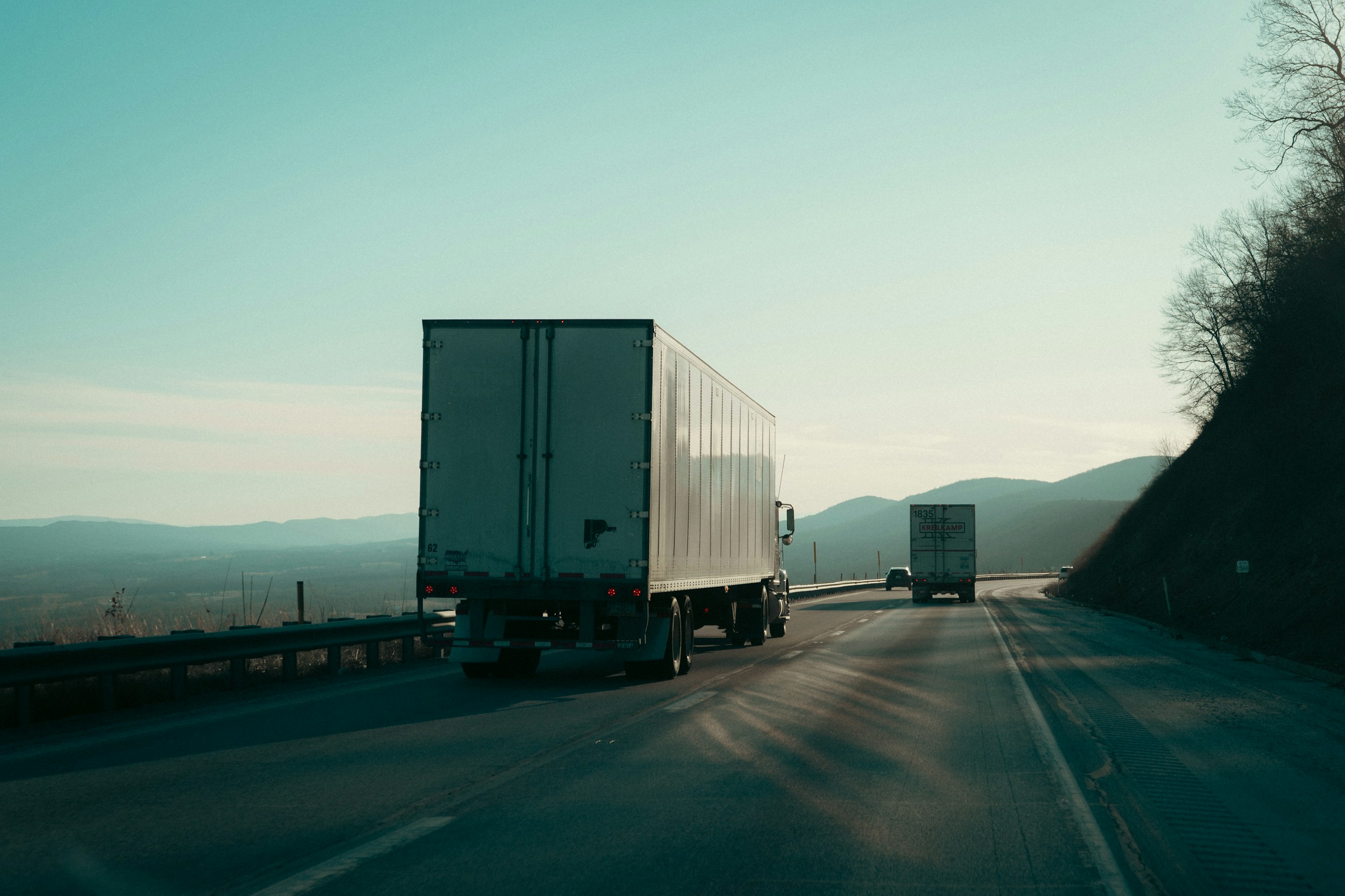 Cargo trucks travelling along a mountain highway